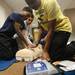 Cass Tech freshman from left, Devin Moses, 14, Redwan Binrouf, 14, and Silas Shorter, 14, practice compressions as they use a defibrillator during a tour o f the Clinical Simulation Center at University of Michigan Hospital on Thursday, Jan. 10. Melanie Maxwell I AnnArbor.com